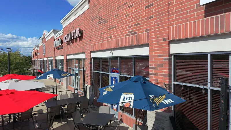 The patio out front with red and blue umbrellas