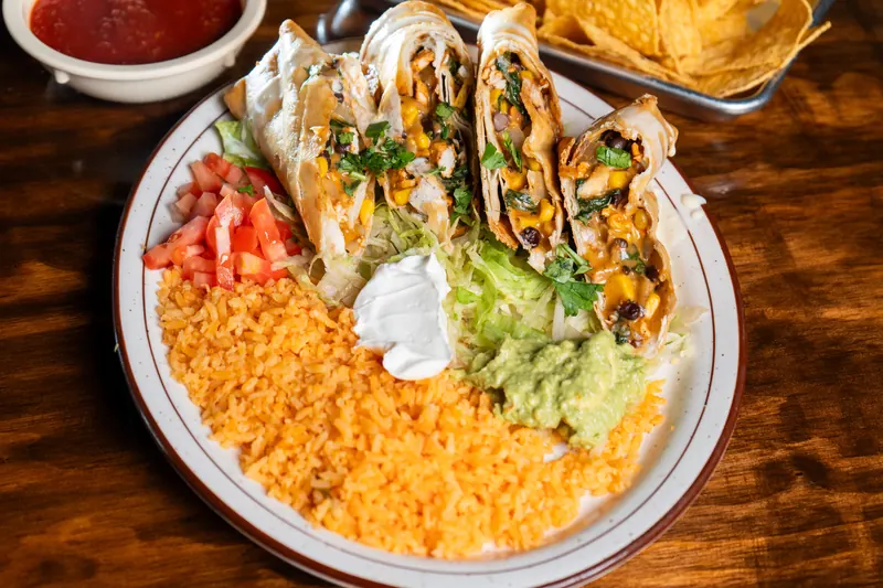Rolled flour tortillas with rice, guacamole and sour cream
