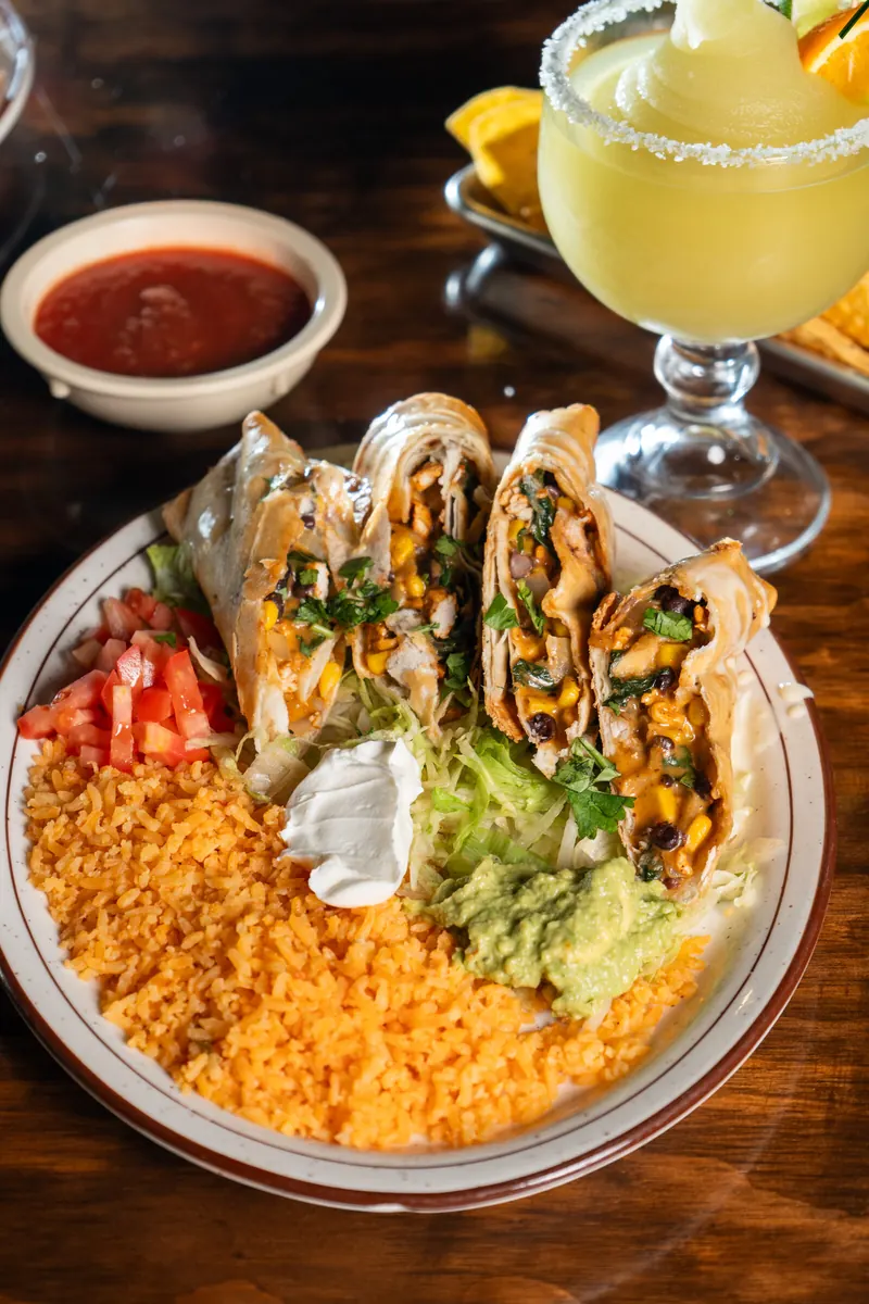 Rolled tortillas with rice, pico de gallo and a margarita